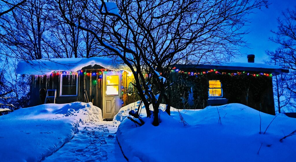 Cabin with snow and Christmas lights